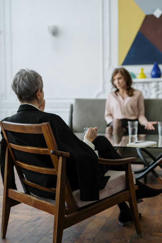 pexels photo 4098221 4098221 A therapist and patient engaged in a counseling session in a modern office setting.