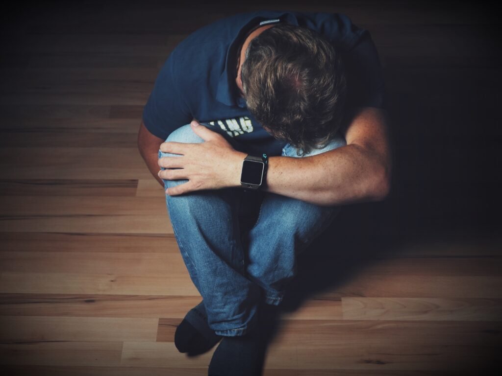 Man sat on floor with his head buried in his knees. Its not just about flashbacks.